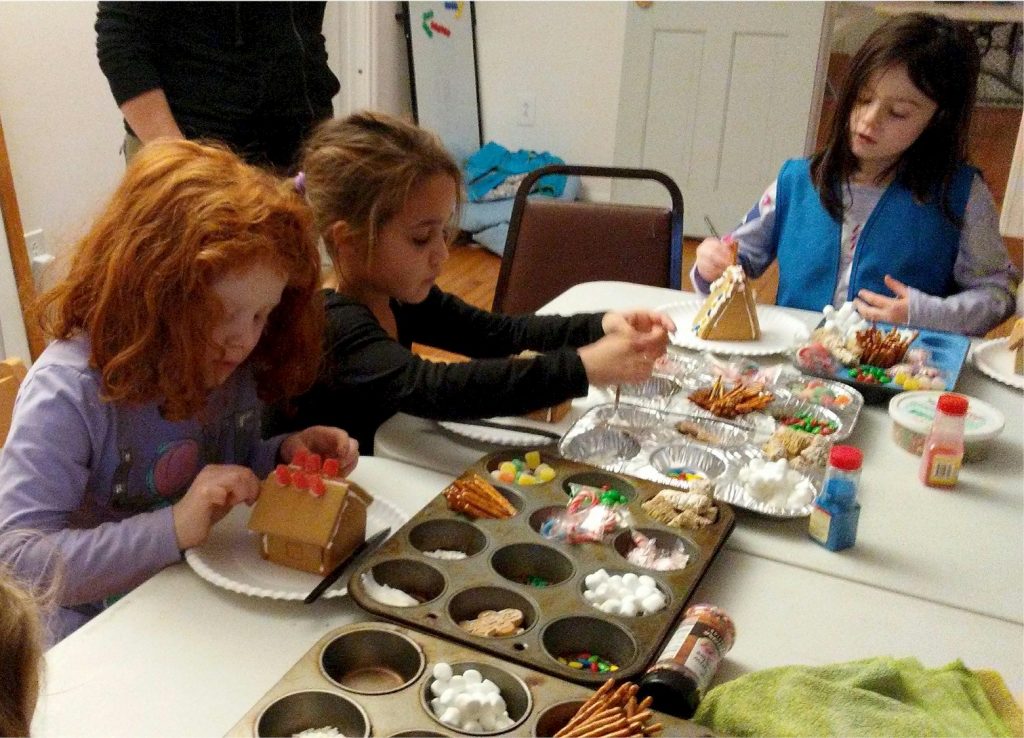 Daisy Girl Scouts making Gingerbread Houses