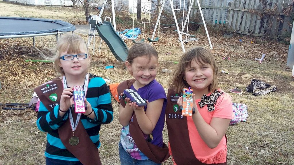 Brownie Girl Scouts show of their derby cars.