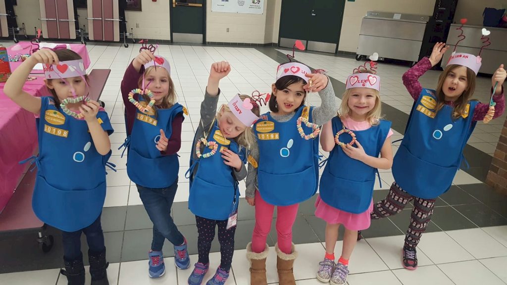 Daisy Girl Scouts making bird treats.