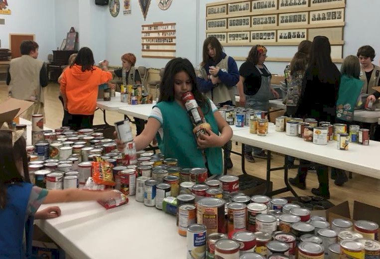 Girl Scouts sorting food for the food bank.