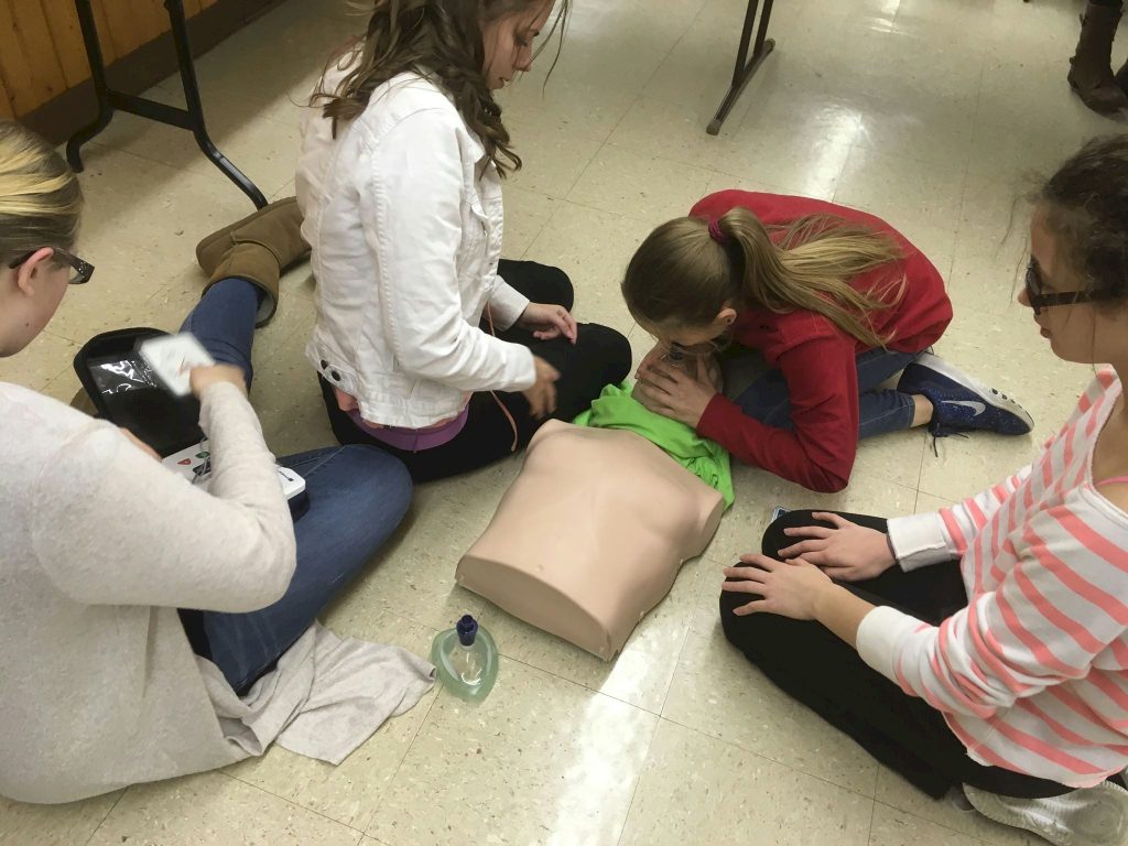 Girl Scouts learning CPR