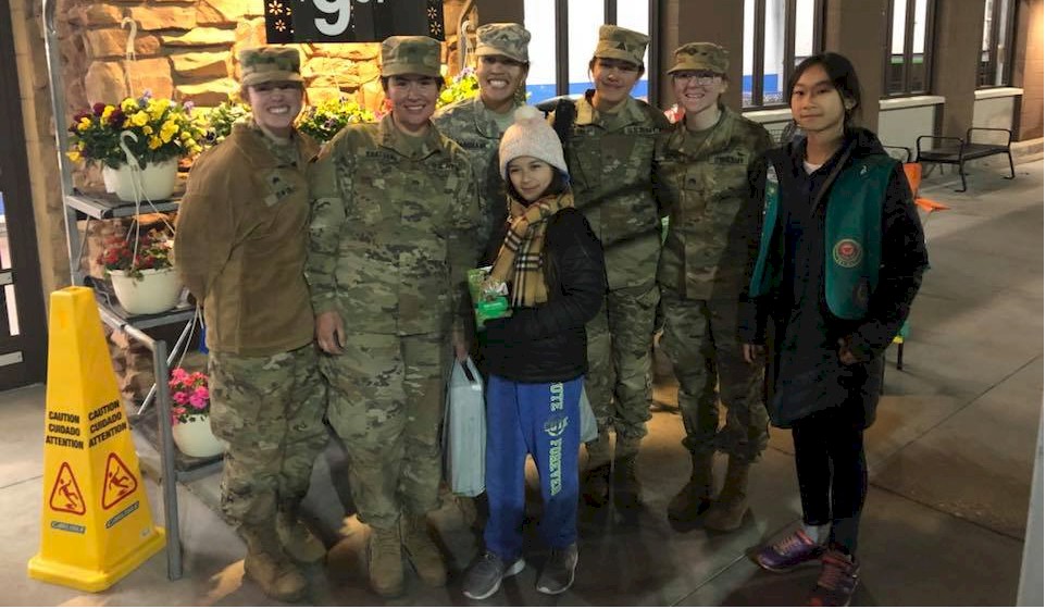Junior Girl Scouts Give Cookies to Women in the Military.