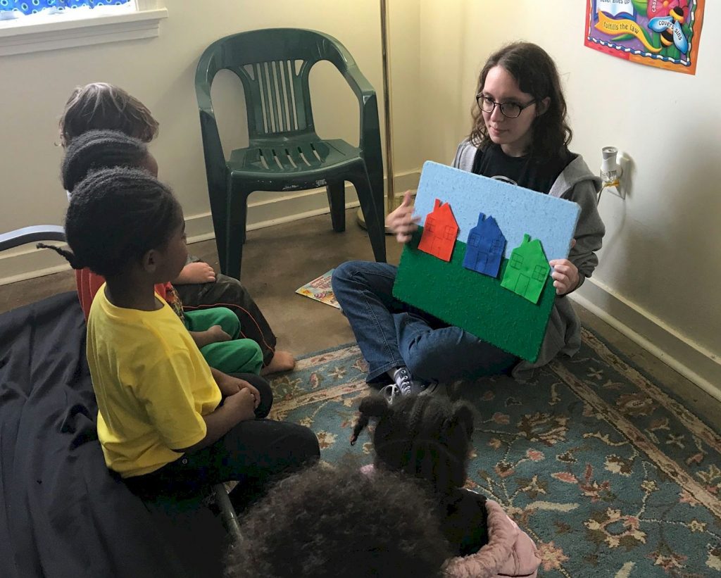 Ambassador Girl Scout doing child care for the homeless.