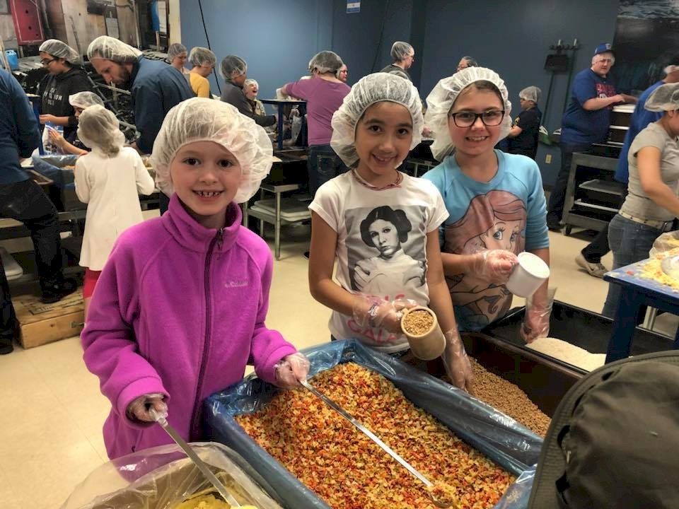 Brownie Girl Scouts Preaparing Meals for Children in Kenya.