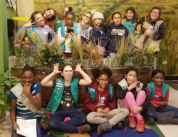 Girl Scouts enhancing a butterfly garden.