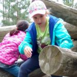 Brownie Girl Scout Climbing on Logs