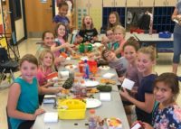Troop 373 Jr. Girl Scouts of Batavia Illinois earn a crafting for sevice patch by making door arrangements for the elderly to hang on their doors in nursing community.